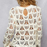 Woman wearing a white crochet top with a gray background