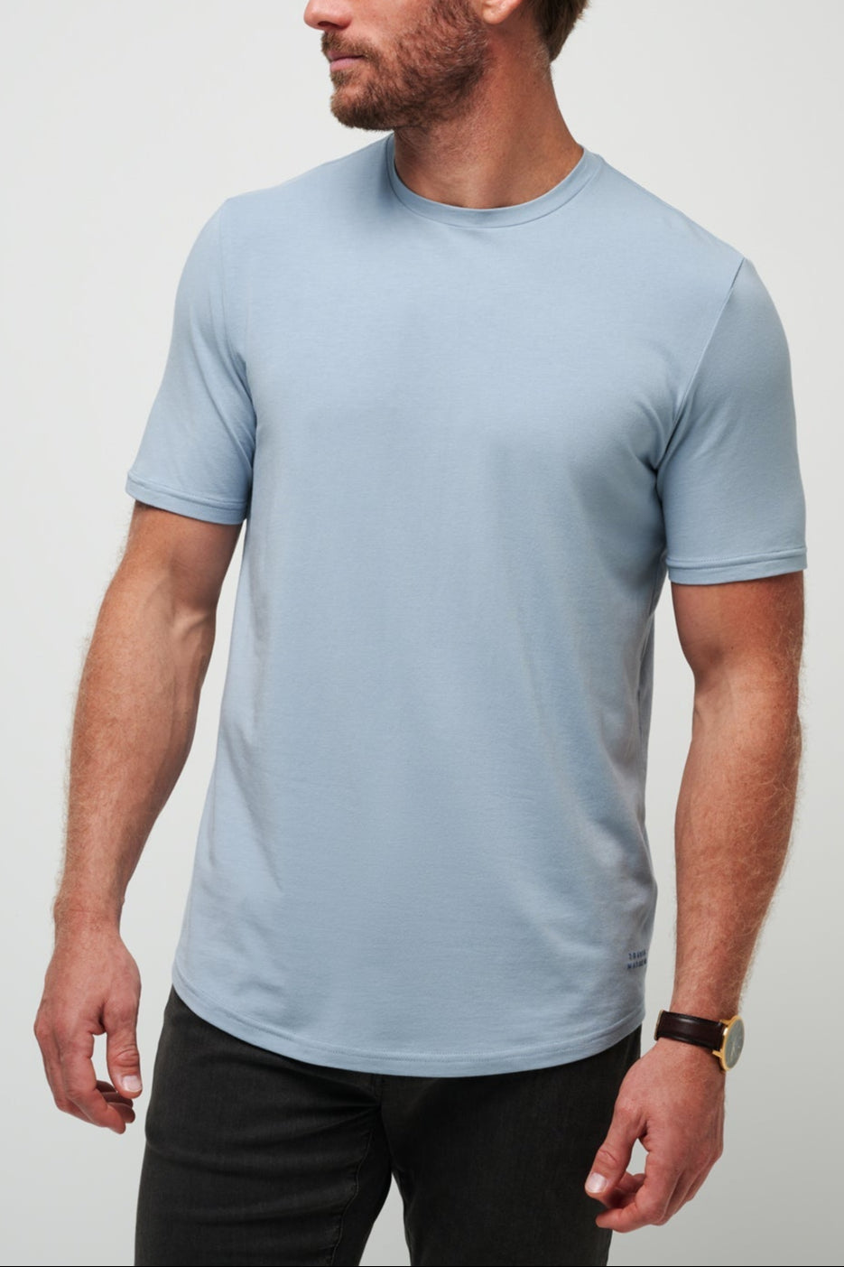 Man wearing a light blue t-shirt against a plain background