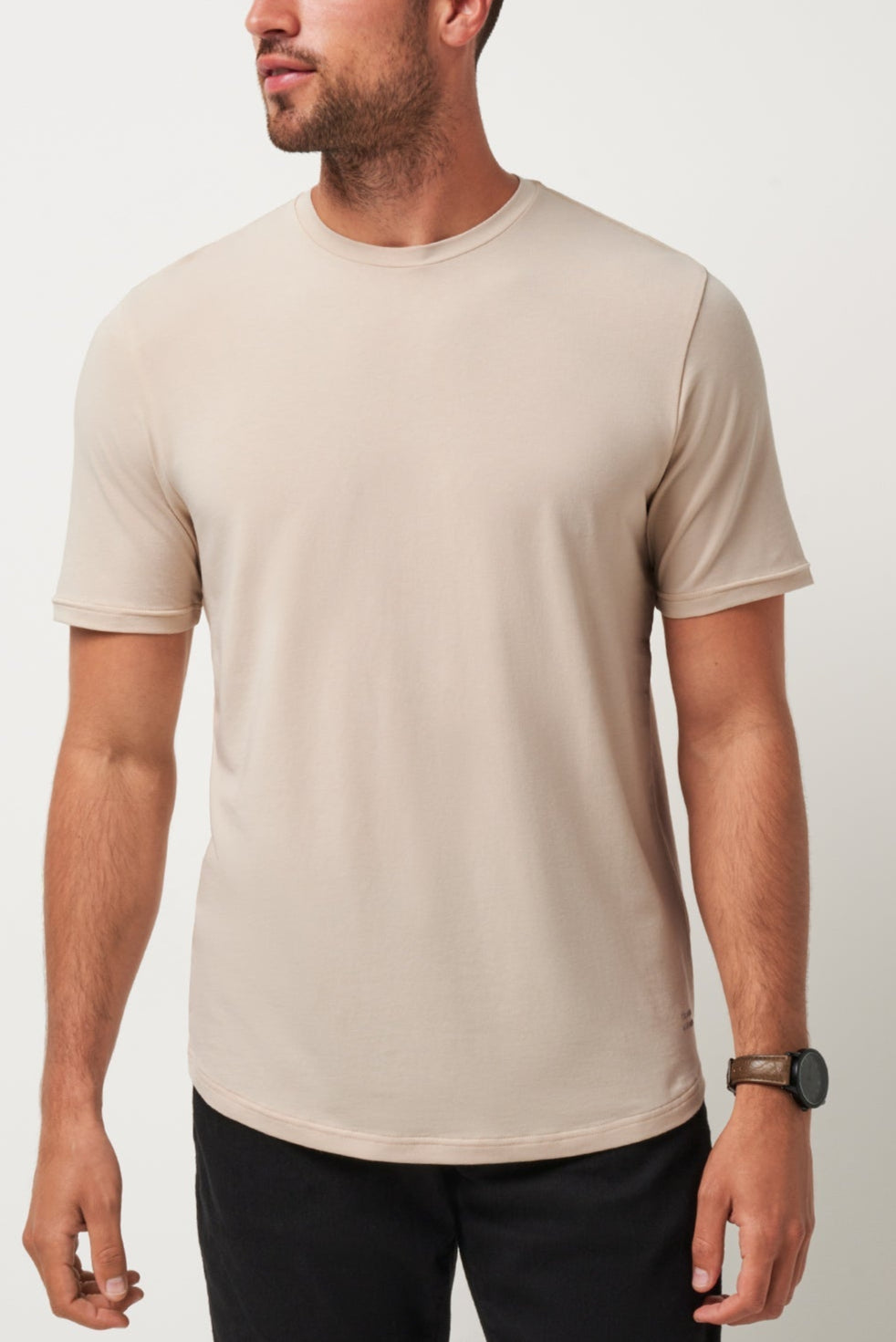 Man wearing a beige t-shirt against a plain background