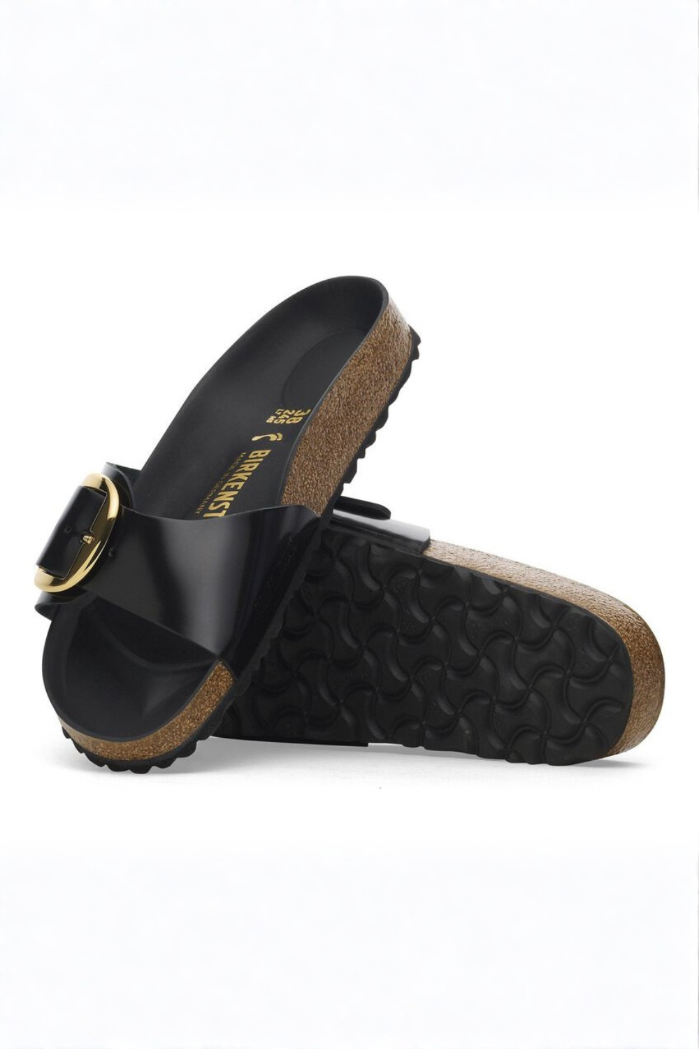 Black birkenstock sandals with cork sole on a white background