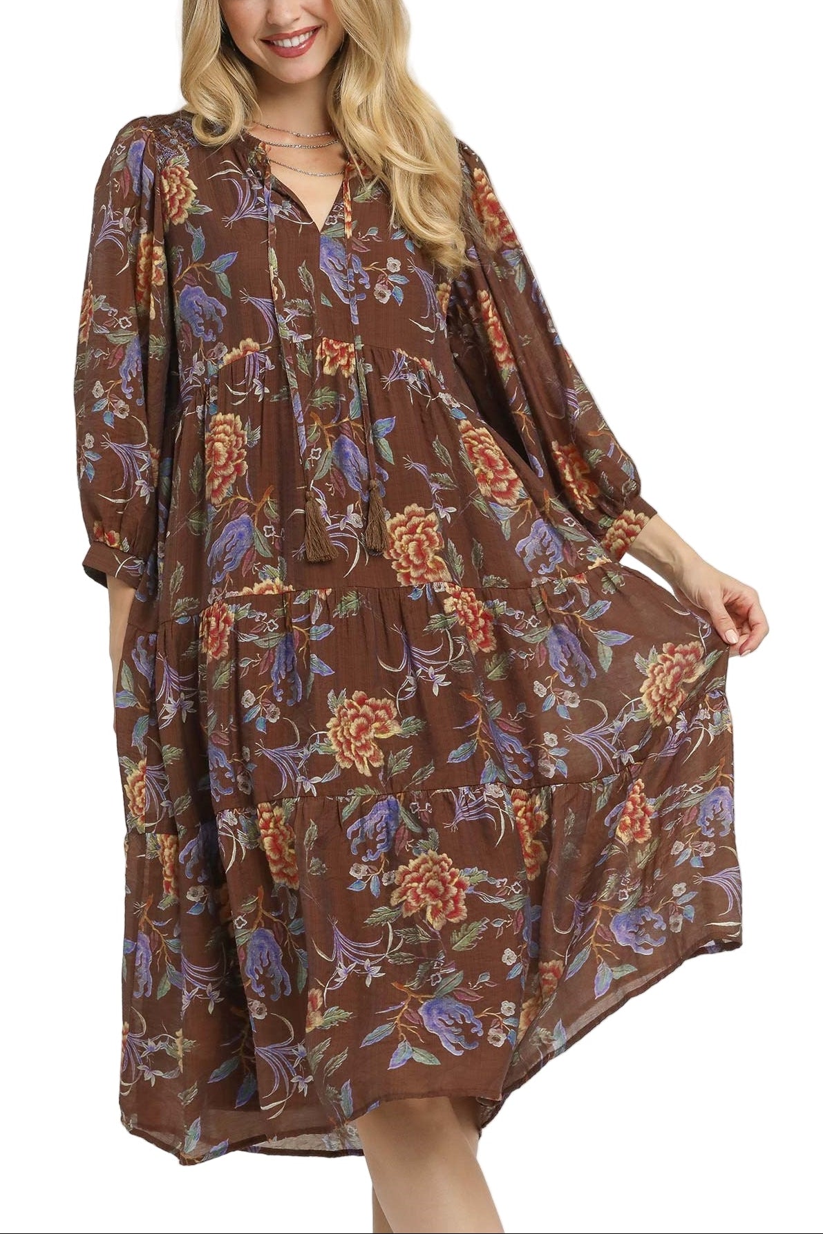 Woman wearing a brown floral dress on a white background