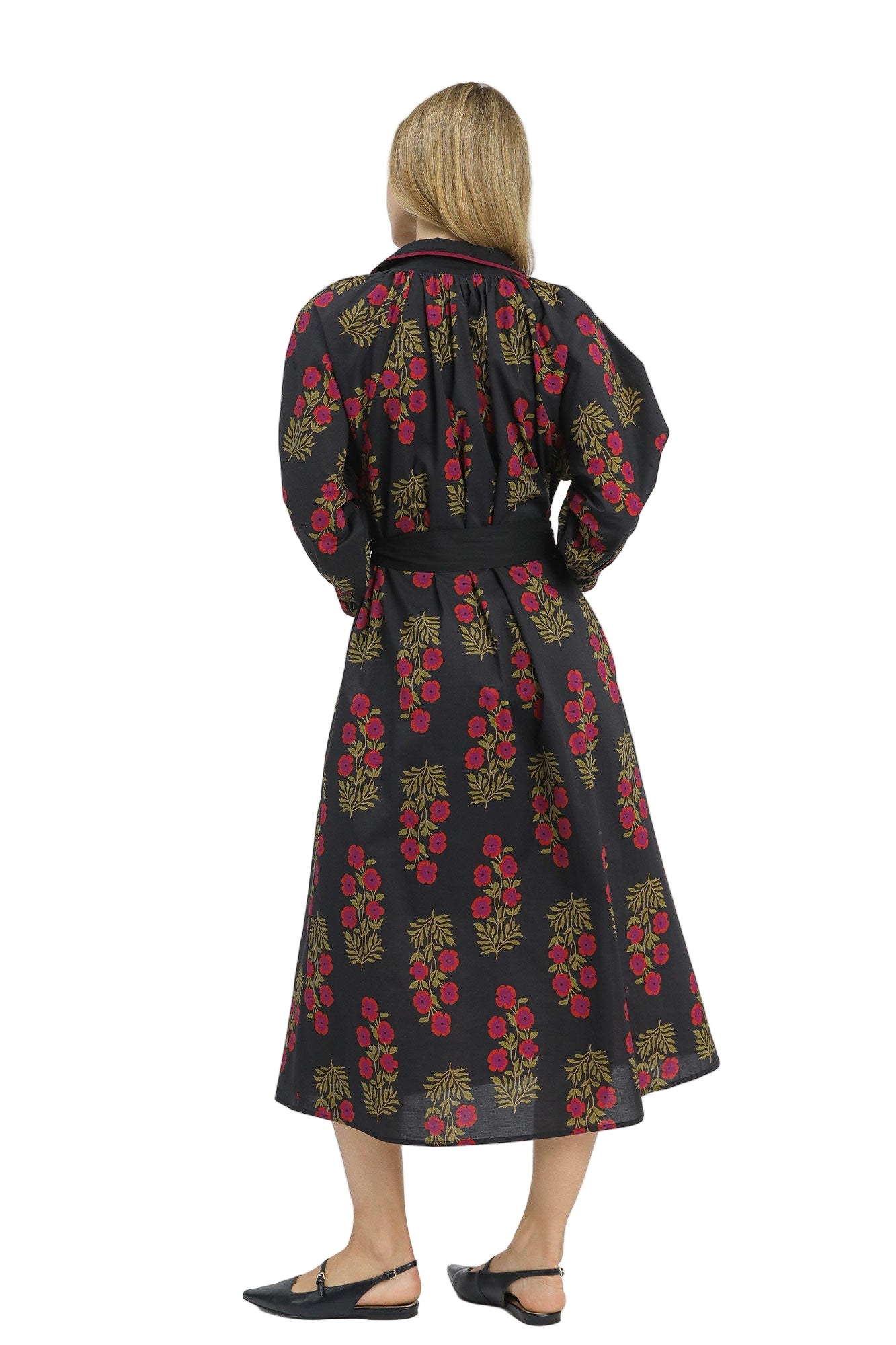 Woman wearing a black floral dress on a white background