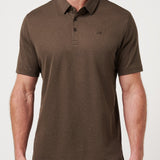 Man wearing a brown polo shirt with a logo on a light gray background