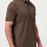 Man wearing a brown polo shirt against a white background