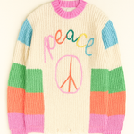 Colorful sweater with 'peace' and peace sign design on a beige background