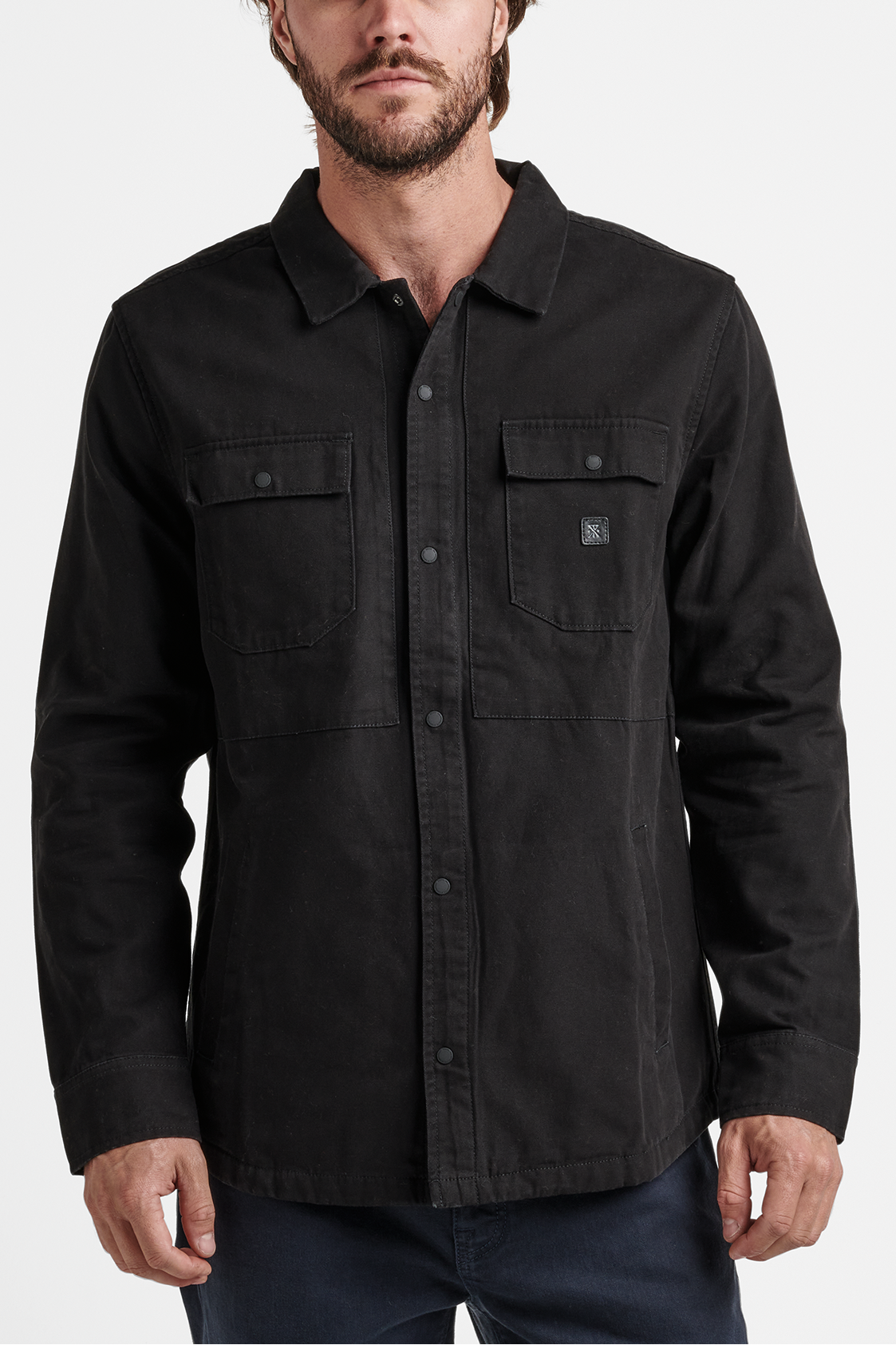 Man wearing a black shirt with a collar on a white background