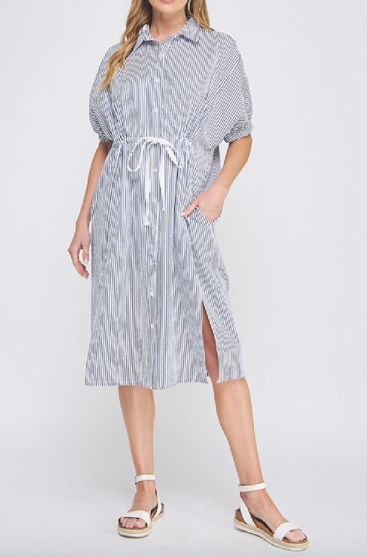 Woman wearing a striped dress with a white background
