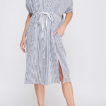 Woman wearing a striped dress with a white background