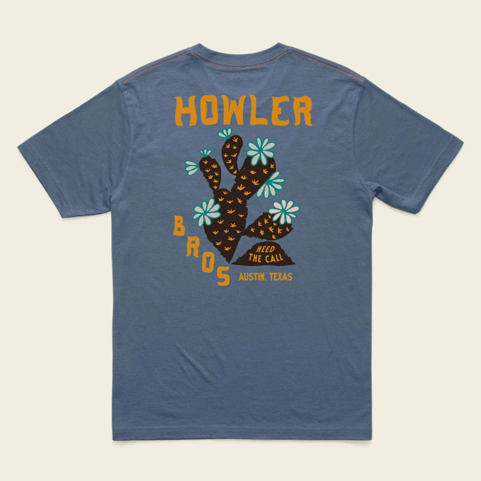 Blue t-shirt with a graphic design and text on the back, displayed on a beige background.