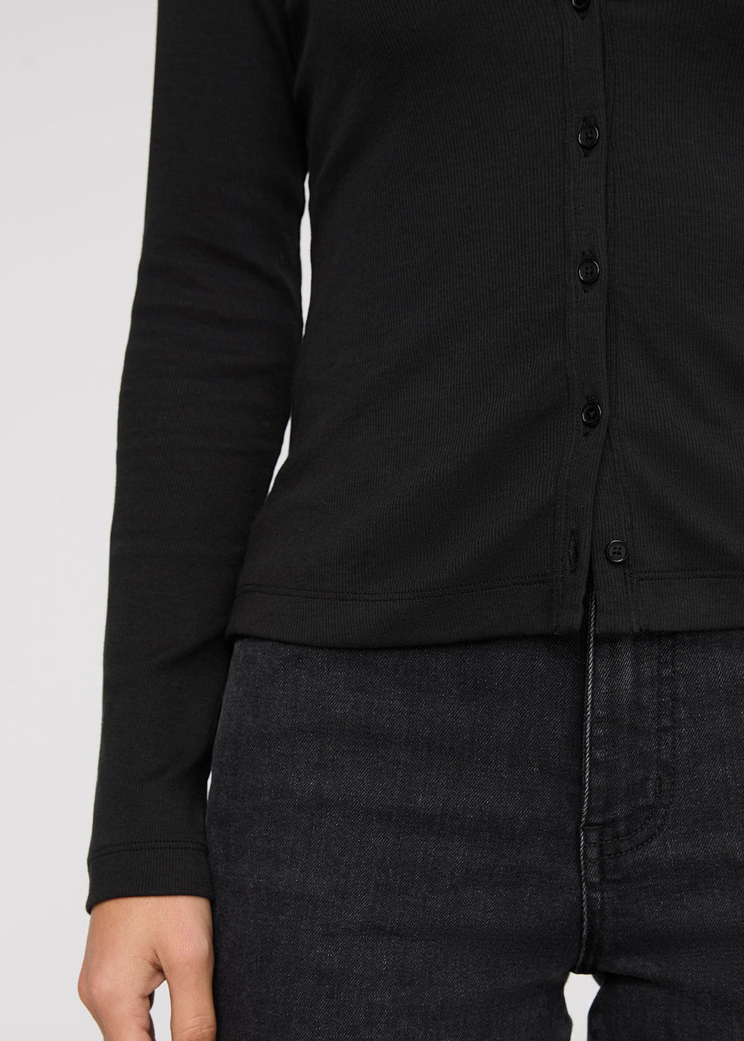 Black button-up shirt worn by a person on a white background