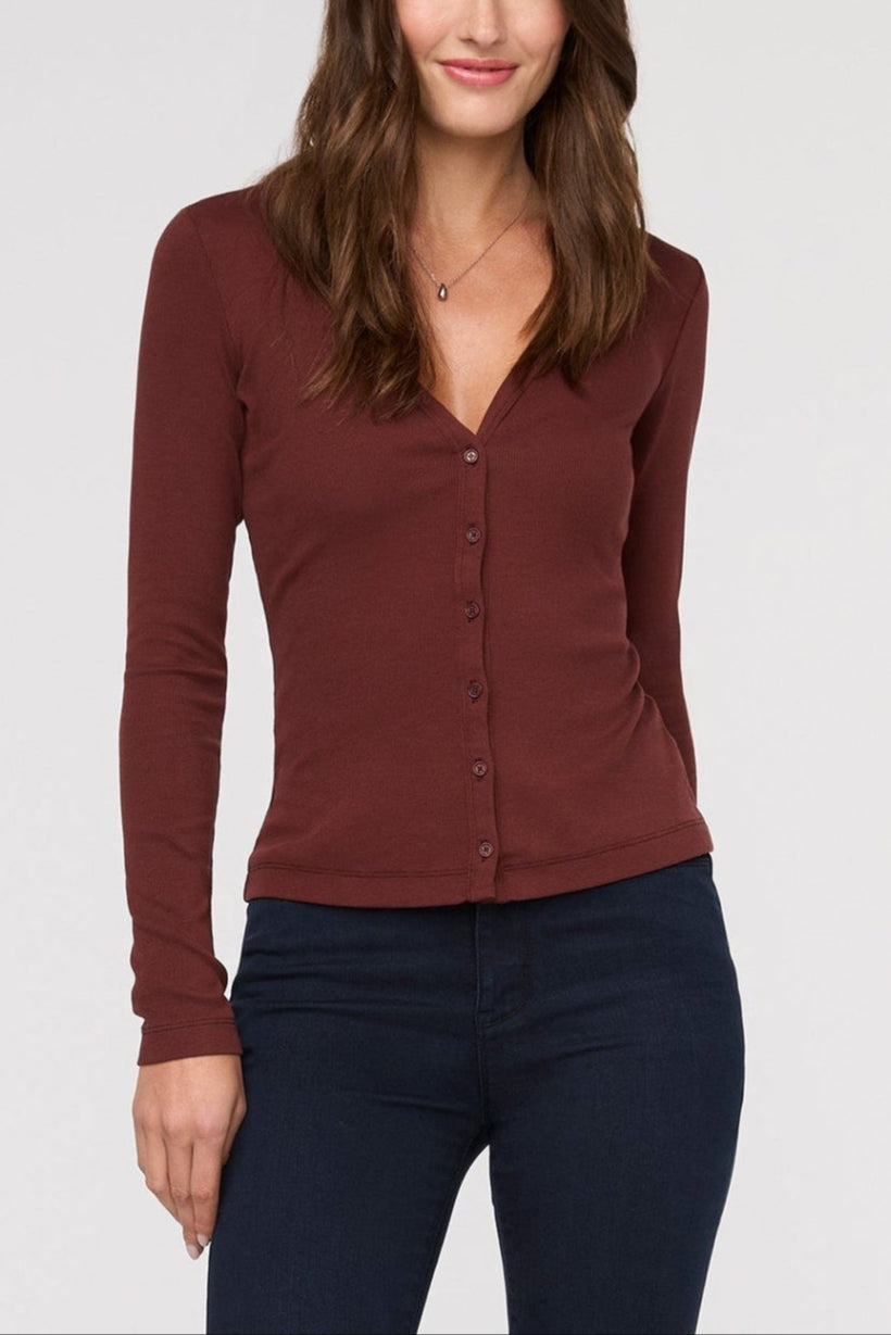 Woman wearing a brown long-sleeve top against a white background