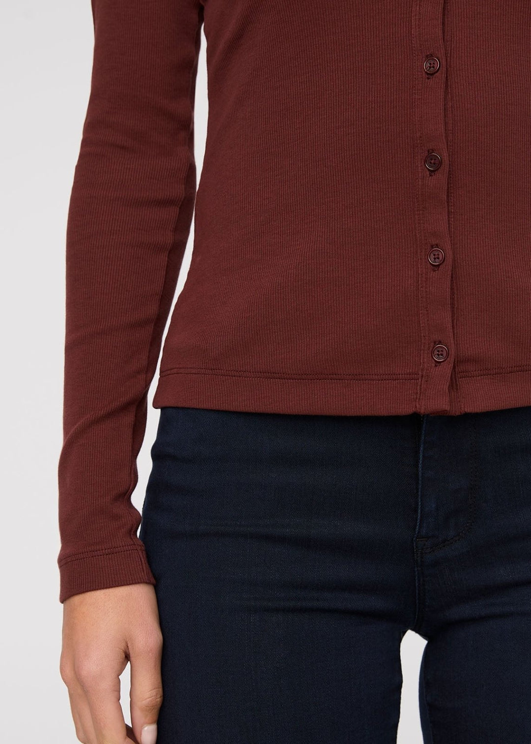 Brown button-up shirt worn by a person on a white background
