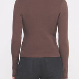 Woman wearing a brown long-sleeve top on a white background