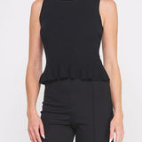 Woman wearing a black sleeveless top with a peplum waist on a white background