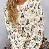 Woman wearing a white lace top with colorful pants against a gray background