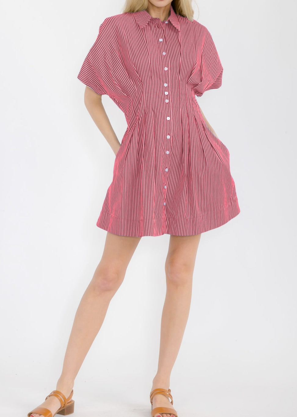 Woman wearing a red and white striped dress on a white background