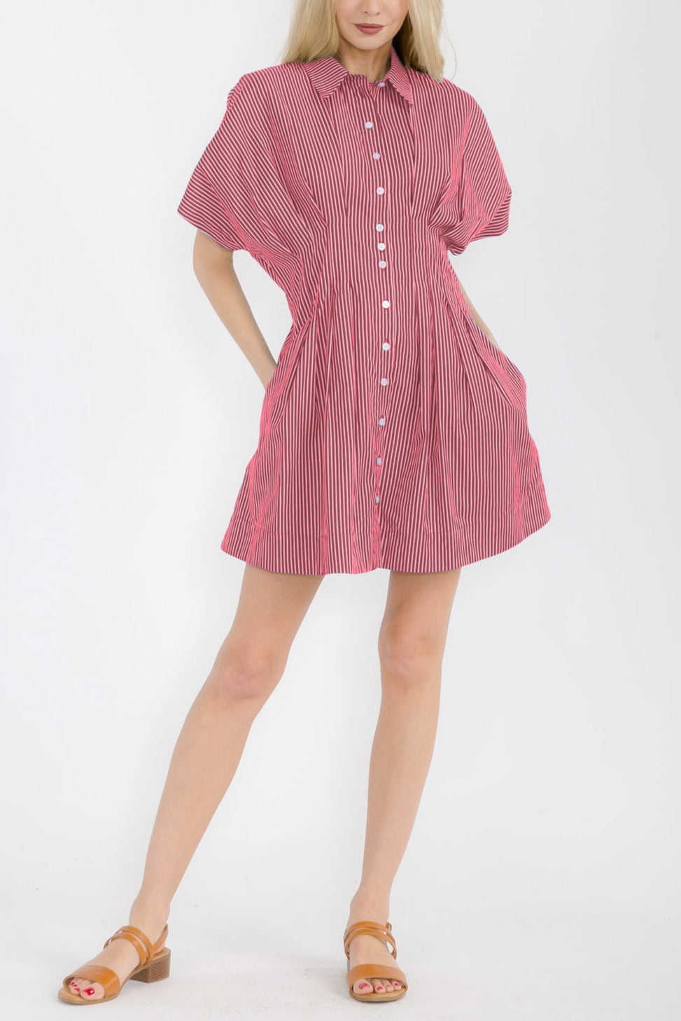 Woman wearing a red and white striped dress on a white background