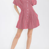 Woman wearing a red and white striped dress on a white background