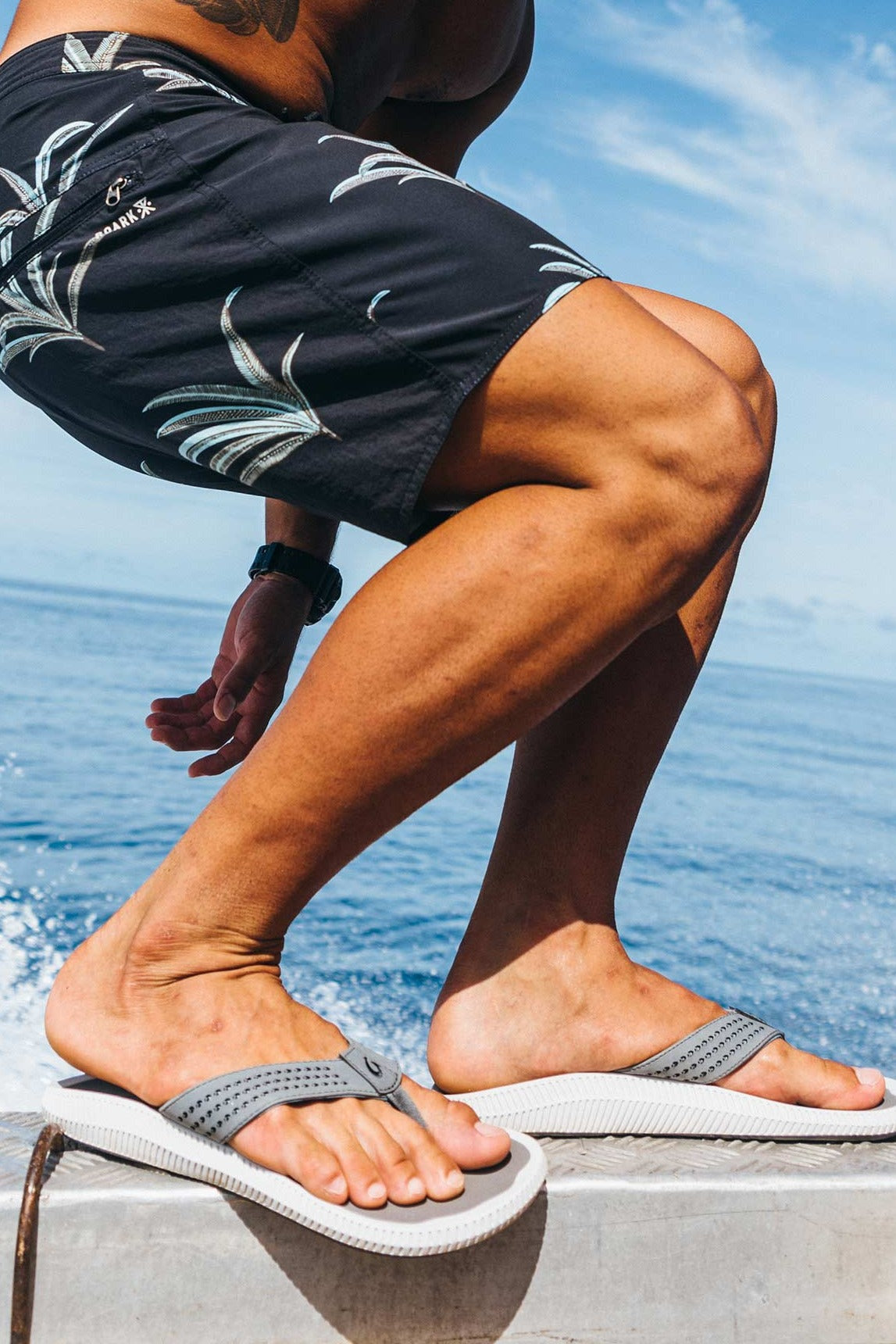 OluKai Ulele Stone sandals worn at the beach