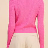Person wearing a pink sweater on a beige background
