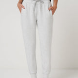 Person wearing gray sweatpants on a plain background