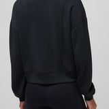 Person wearing a black jacket and pants on a plain background