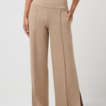 Beige high-waisted pants worn by a person on a white background