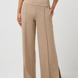 Beige high-waisted pants worn by a person on a white background
