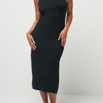 Woman wearing a black sleeveless dress against a white background