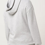 Person wearing a gray hoodie and shorts set on a white background
