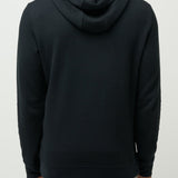 Man wearing a black hoodie from behind on a light gray background