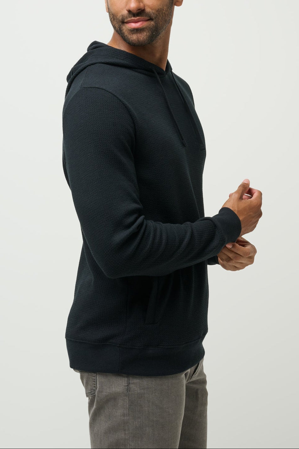 Man wearing a black hoodie against a plain background