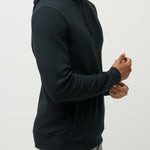 Man wearing a black hoodie against a plain background