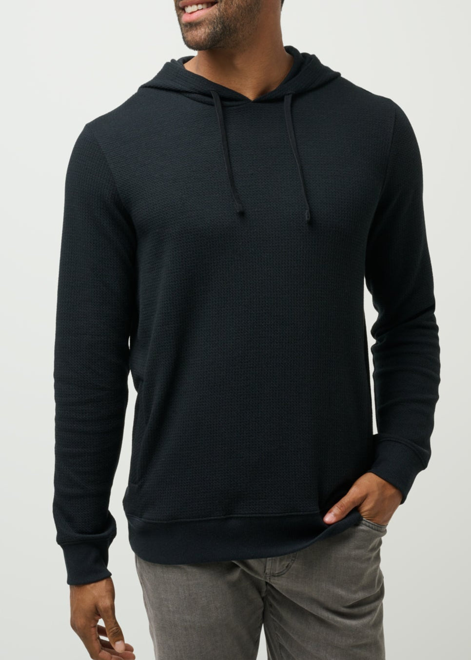 Man wearing a black hoodie on a light gray background
