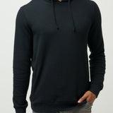 Man wearing a black hoodie on a light gray background