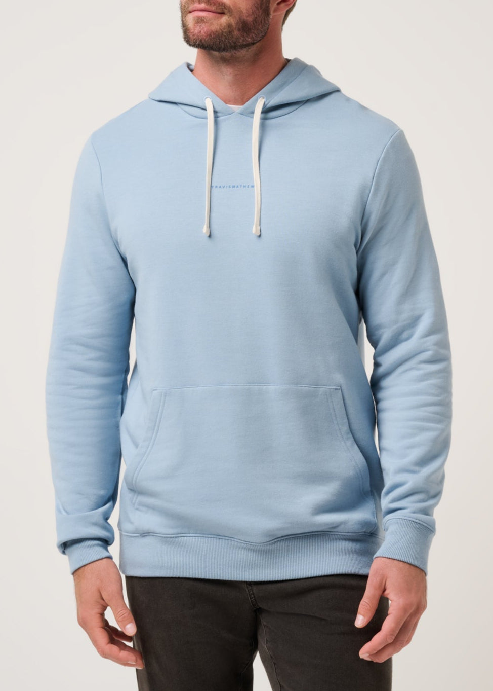 Man wearing a light blue hoodie against a plain background