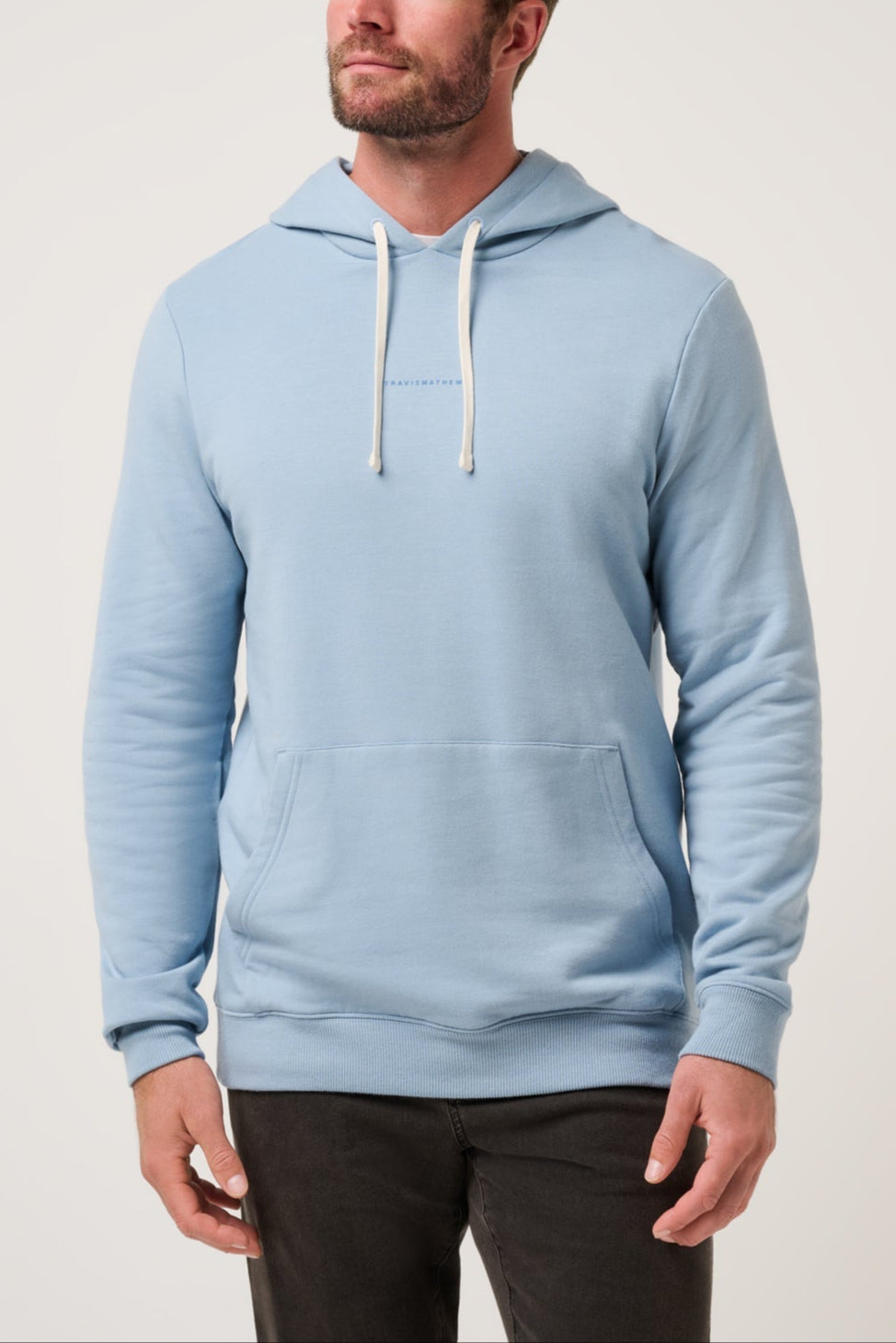 Man wearing a light blue hoodie against a plain background