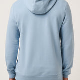 Man wearing a light blue hoodie from behind on a plain background
