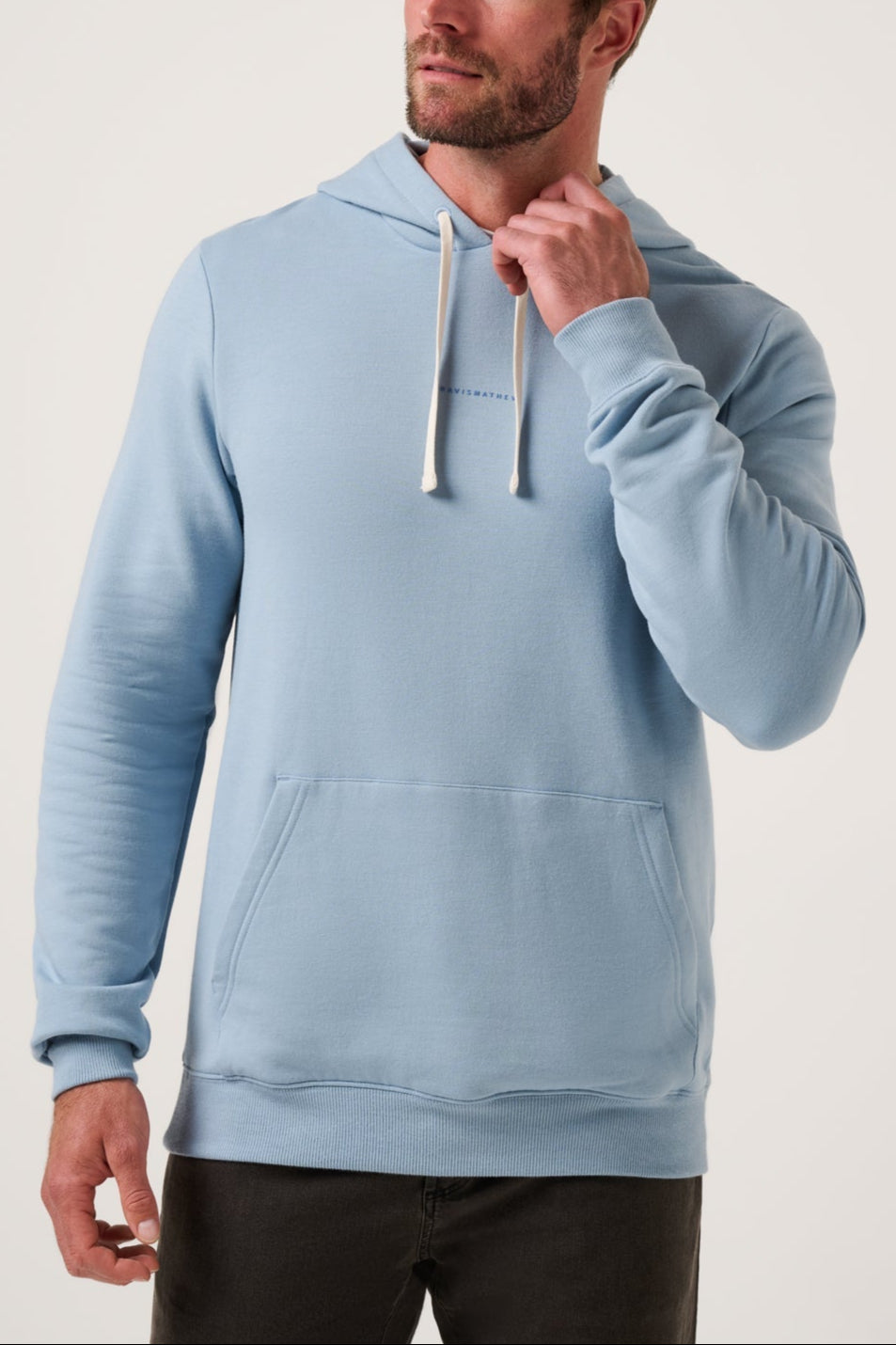 Man wearing a light blue hoodie against a plain background