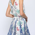 Woman wearing a floral patterned dress on a white background