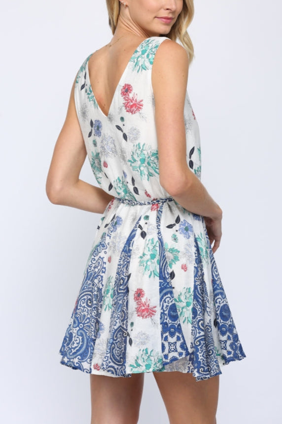 Woman wearing a floral patterned dress on a white background