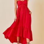 Woman wearing a red dress against a beige background