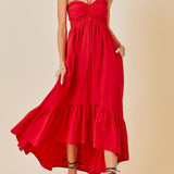 Woman wearing a red dress against a beige background