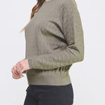 Woman wearing a green sweater on a white background
