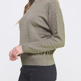 Woman wearing a green sweater on a white background