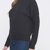 Woman wearing a black sweater and blue pants on a white background