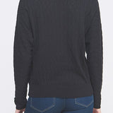 Woman wearing a black sweater and blue jeans on a white background