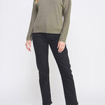 Woman wearing a green sweater and black pants on a white background
