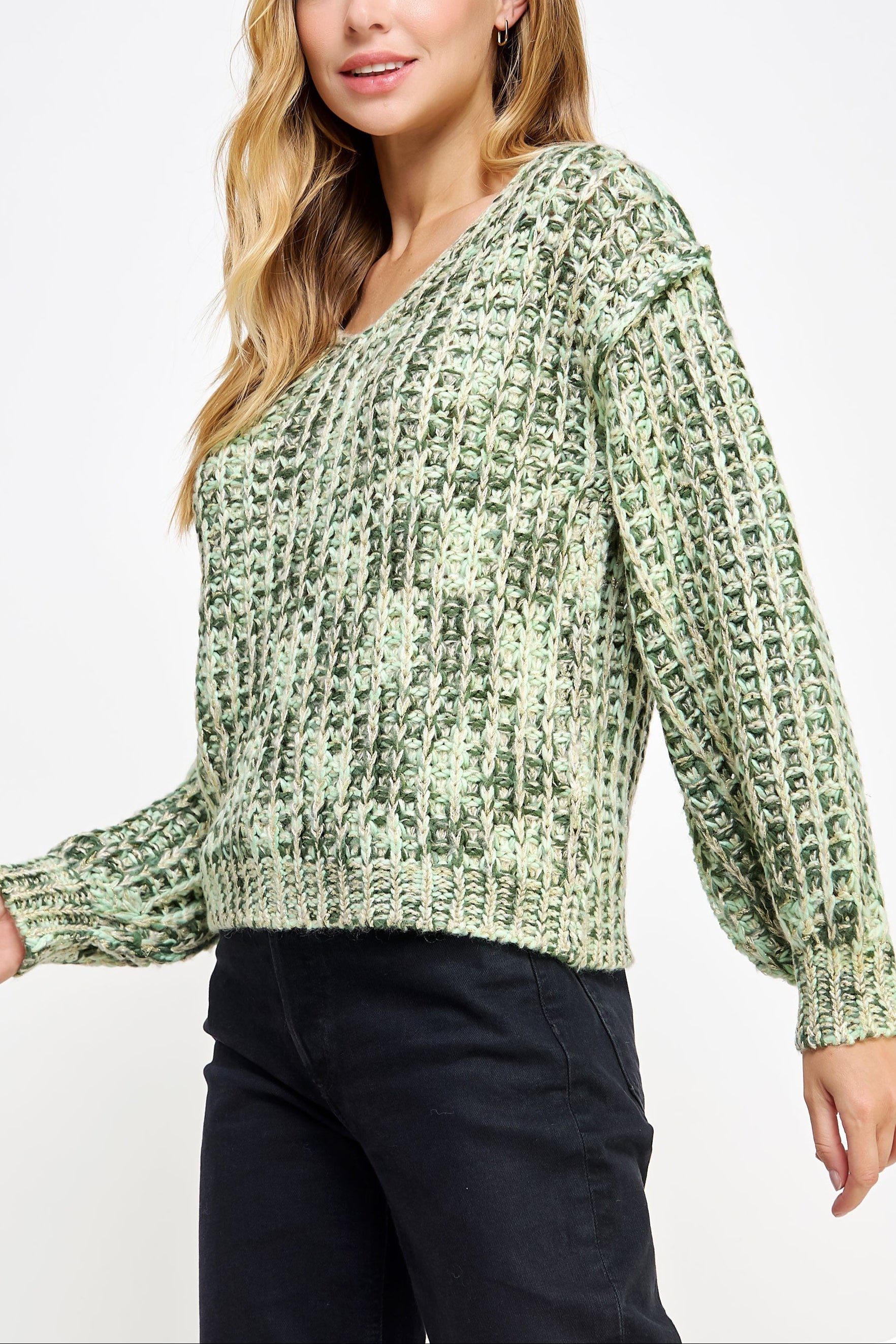 Woman wearing a green patterned sweater on a white background