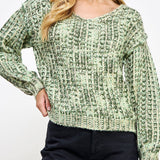 Woman wearing a green patterned sweater on a white background